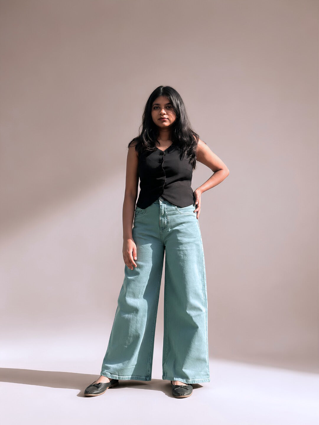 Light blue wide-leg jeans for short height women styled with a black vest, full length