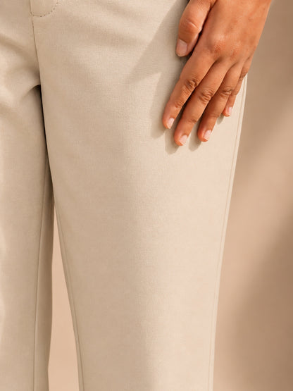 Close-up of beige straight-fit formal trouser fabric, petite office wear