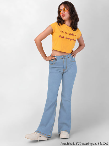Light blue bootcut jeans for short girls under 5 feet 3, styled with a yellow crop top